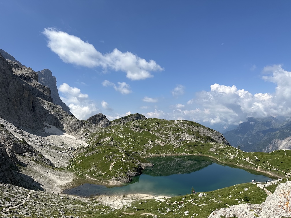 Coldai Lake, immediately above the refuge and the homonymous saddle, at 2143 mt. On the left in the background is a glimpse of the huge west face of Civetta.